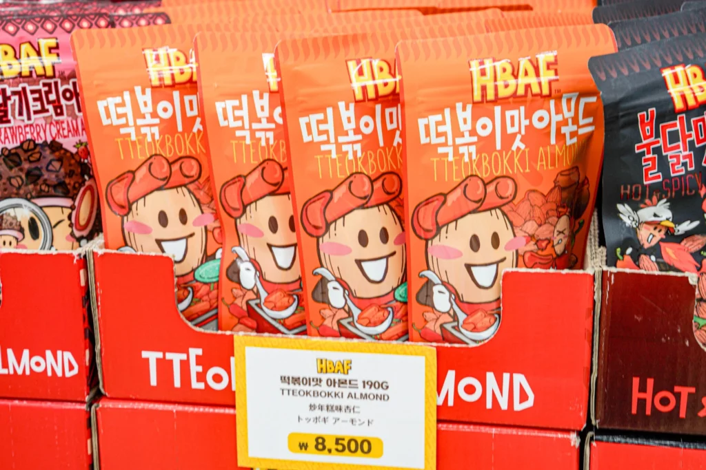 HBAF Tteokbokki Almond bag displayed at the store, featuring the spicy-sweet Korean street food flavor in red packaging.
