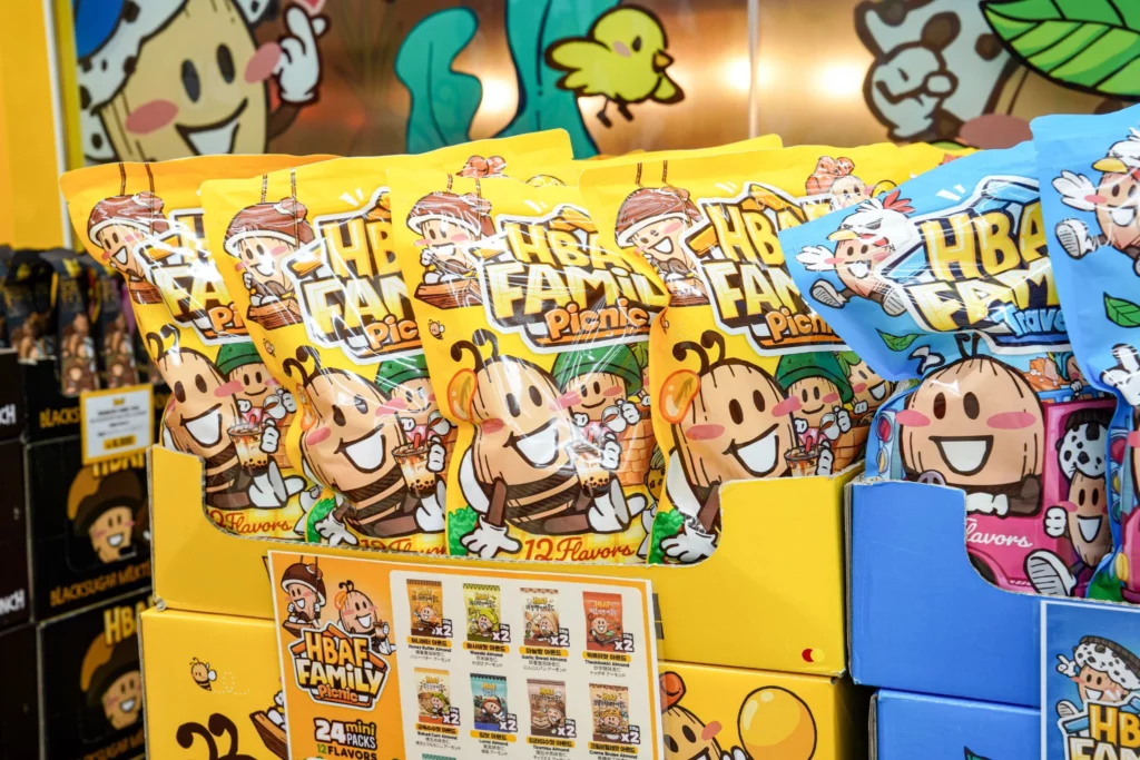 HBAF Family Picnic variety pack containing 24 mini bags across 12 Korean flavored almond flavors, displayed in yellow packaging at the store.