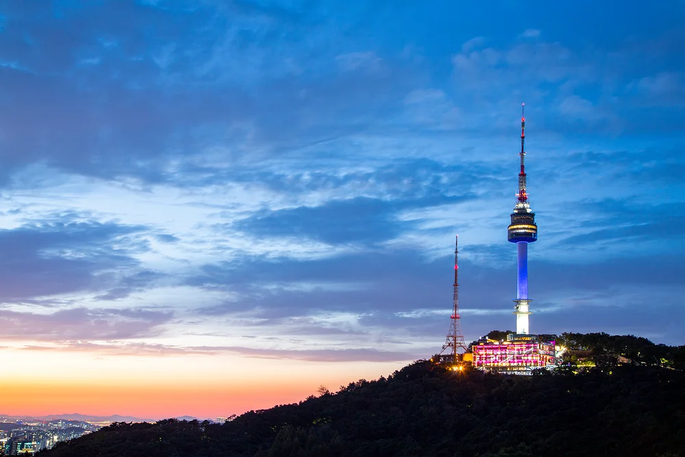 N Seoul Tower illuminated at dusk, a landmark near Durumi Bunsik in central Seoul