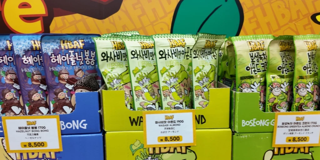 HBAF Wasabi Almond 190g pouches priced at ₩8,500 displayed next to Hazelnut Bong Bong and Boseong Green Tea Almond varieties.