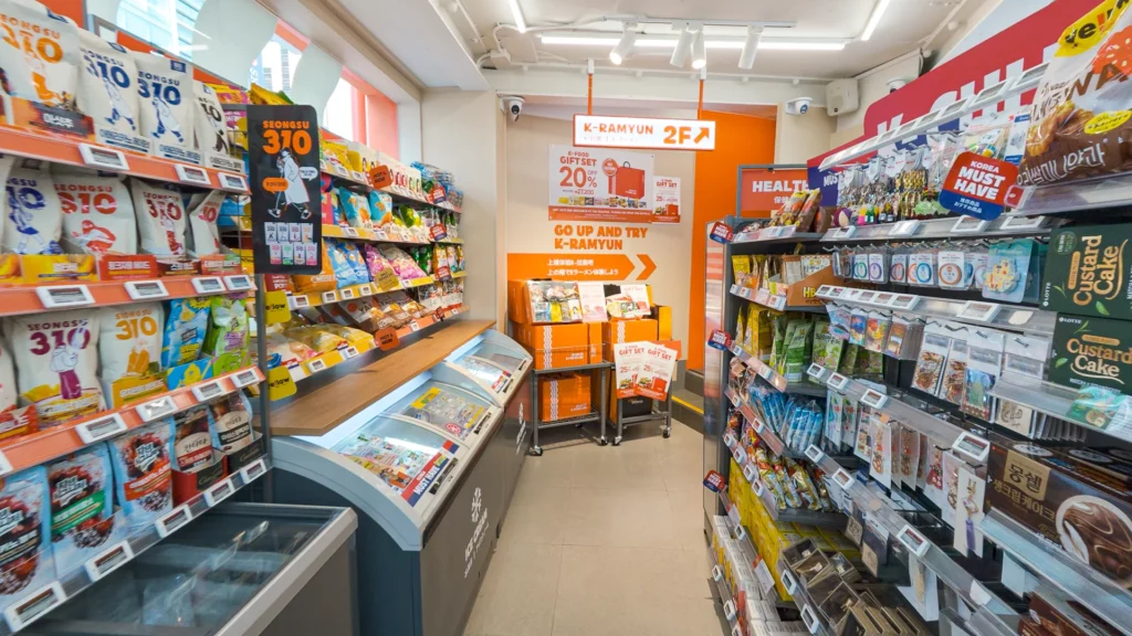 Ground-floor aisle showing Seongsu 310 chips, K-Food gift sets, and an orange 