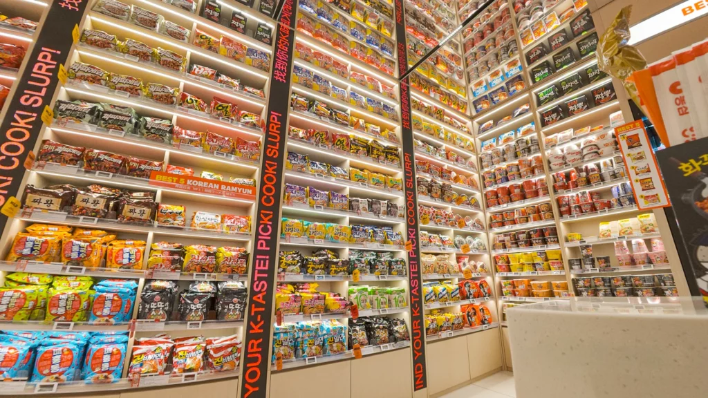 Second-floor ramyeon shelves sorted by spice level with Best 5 Korean Ramyun marker and 