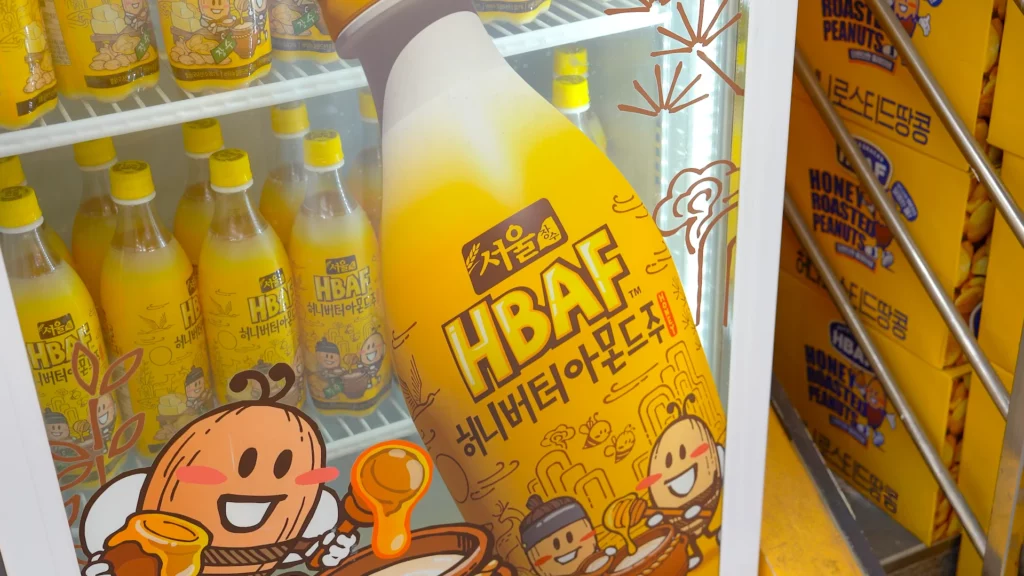 Close-up of HBAF Honey Butter Almond Makgeolli bottle inside the refrigerator at HBAF Almond Store Myeongdong.