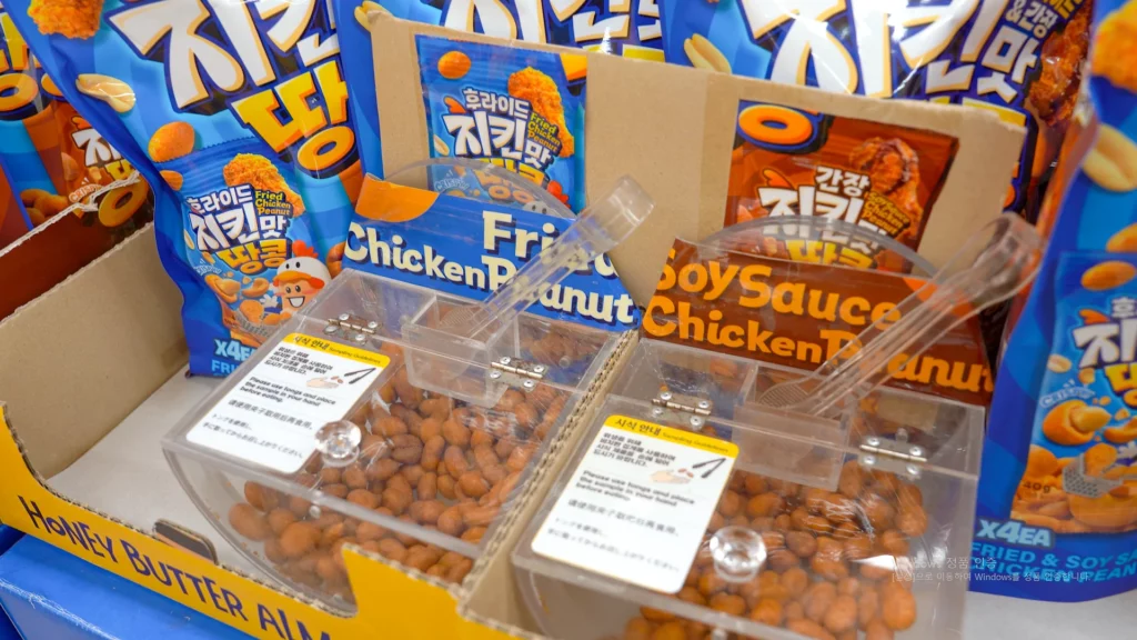 HBAF Fried Chicken Peanut and Soy Sauce Chicken Peanut sampling stations with tongs for tasting at the Myeongdong store.
