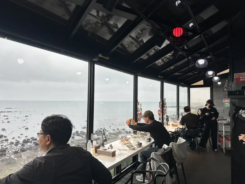 Ocean-view dining counter overlooking Aewol's rocky coastline at this BTS favorite Jeju restaurant.
