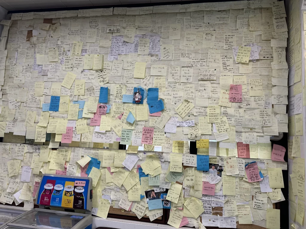 Wall covered with handwritten guest notes and fan messages left at this BTS favorite Jeju restaurant